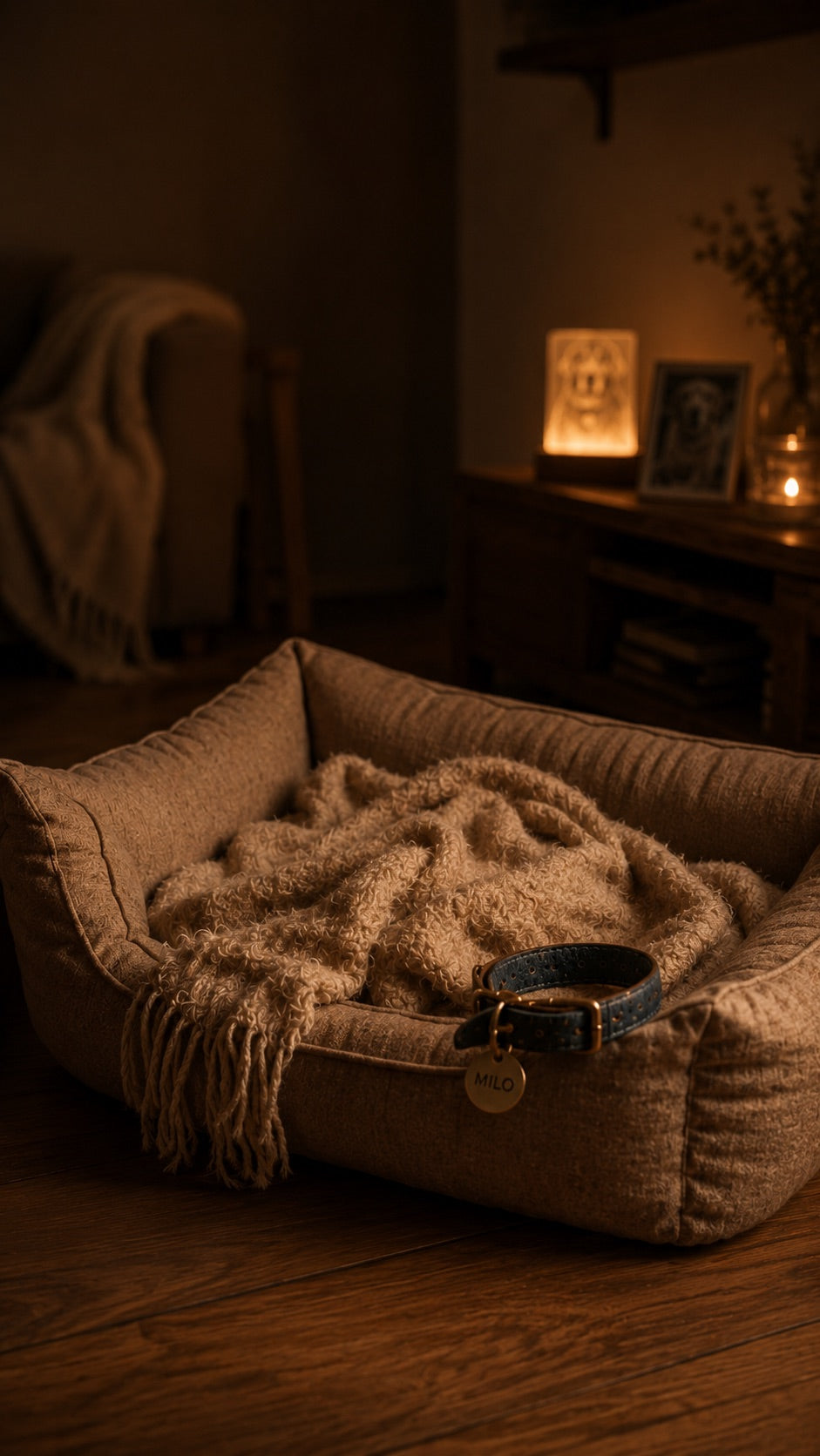 A warm bedroom at night, a small memorial lamp glowing on the shelf